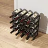 A black metal wine rack filled with 16 bottles of wine, placed on a light wood floor next to a white wall. Náhled obrázku produktu