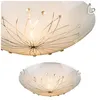 A close-up view of a white ceiling light with a decorative dandelion-like pattern and small crystal accents. Anteprima dell’immagine prodotto