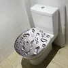 A toilet seat with a water droplet design in a bathroom. Produktbild-Vorschau