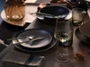 A table setting with plates, cutlery, a wine glass, and a vase. Náhľad obrázku produktu