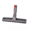 A vacuum cleaner attachment with brushes and red and gray buttons. Produktbild-Vorschau
