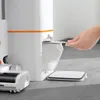 A hand is shown inserting a dust bag into a white and orange cleaning device, with a floor cleaning attachment nearby. Náhľad obrázku produktu