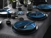 A table setting with blue ceramic plates and bowls, wine glasses, and candles. Náhľad obrázku produktu