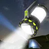 A large flashlight illuminates a tent and the surrounding landscape at night. Produktbild-Vorschau