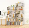 A white, modern, multi-tiered geometric bookshelf filled with various decorative items and books, placed against a white wall next to a window with blinds. Náhľad obrázku produktu