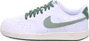 A side view of a white Nike Court Vision Low sneaker with green accents. Produktbild-Vorschau