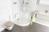 A modern bathroom with a toilet, shower, and vanity. Produktbild-Vorschau