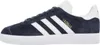 A side view of a navy blue Adidas Gazelle sneaker with white stripes and gold lettering. Produktbild-Vorschau