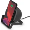 A black wireless charging stand with a smartphone on it, showing it is 100% charged. Produktbild-Vorschau