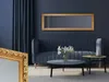 A living room scene with a blue sofa, coffee table, and a gold-framed mirror on the wall. Produktbild-Vorschau