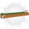 A wooden planter box filled with green plants and a few pink flowers, with a "Designed in Germany" label on the side. Produktbild-Vorschau