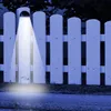 A white picket fence with a solar-powered LED light illuminating one section. Produktbild-Vorschau