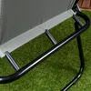 Close-up of the frame and fabric of a camping chair on artificial grass. Náhled obrázku produktu