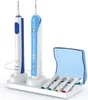 Two electric toothbrushes and four brush heads on a white stand with a blue travel case. Náhľad obrázku produktu