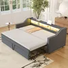 A dark gray sofa bed is pulled out into a bed, with a beige blanket on top. The sofa has a built-in shelf with LED lighting and USB ports. Voir les images du produit
