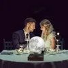 A couple is having a romantic dinner outdoors at night, with a levitating moon lamp on the table. Náhled obrázku produktu