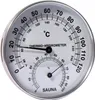A close-up of a round thermo-hygrometer with a silver metal frame and a white face displaying temperature in Celsius and Fahrenheit, and humidity in percentage. Náhled obrázku produktu