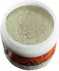 A close-up view of a white container filled with a light green powder, likely a cosmetic or skincare product. The container has a decorative band around its base with red and orange patterns. Náhľad obrázku produktu