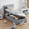 A child's bedroom with a bed that has storage underneath, a desk with a laptop, and toys on the floor. Produktbild-Vorschau
