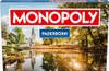 The image shows the front of a Monopoly Paderborn board game box, featuring a scenic view of a city with a reflection in the water. Produktbild-Vorschau