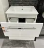 A white bathroom vanity with a sink and an open drawer, displaying product information labels. Náhled obrázku produktu