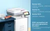 A printer and toner cartridge are shown on a desk with a blue drawer unit, against a light blue wall. Produktbild-Vorschau