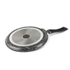 The underside of a frying pan is shown against a white background. Voir les images du produit