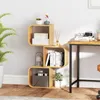 A wooden S-shaped bookshelf with various items on display, next to a desk. Podgląd zdjęcia produktu