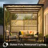 An outdoor patio area with furniture and string lights. Anteprima dell’immagine prodotto