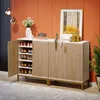 A shoe cabinet with its door open, displaying shoes on shelves, placed against an orange wall with decorative items on top. Anteprima dell’immagine prodotto