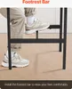 A person's legs and feet are shown resting on a footrest bar of a table. Podgląd zdjęcia produktu