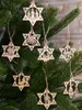 Wooden Christmas ornaments in the shape of stars hanging on a Christmas tree. Náhľad obrázku produktu