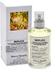 A bottle of Maison Margiela Replica Under The Lemon Trees Eau de Toilette and its packaging. Podgląd zdjęcia produktu