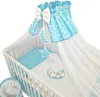 A baby crib with bedding and a canopy. Produktbild-Vorschau