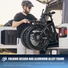 A man is loading a folded electric bicycle into the back of a vehicle. Produktbild-Vorschau