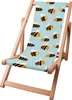 A wooden deck chair with a blue fabric seat featuring a pattern of cartoon bees. Náhled obrázku produktu