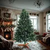 A decorated living room with a Christmas tree in the center, a fireplace with stockings, and furniture. Produktbild-Vorschau