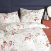 A close-up view of a duvet cover and pillowcase set with a Christmas-themed snowman print, laid out on a bed. Produktbild-Vorschau