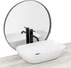 A white oval countertop sink with black faucets is shown in front of a round mirror. Náhled obrázku produktu