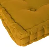 A close-up view of a mustard yellow floor cushion. Náhled obrázku produktu