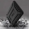 A black laptop case is shown in a dynamic, dramatic scene, appearing to be dropped or impacting a surface, with debris flying outwards. The background is a dark, textured gray. Produktbild-Vorschau
