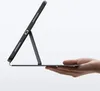 A hand holding a tablet case with a tablet inside, propped up by its stand. Produktbild-Vorschau