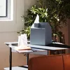 A modern living room setting with a tissue box and a drink on a side table. Anteprima dell’immagine prodotto