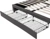 A close-up view of a bed frame with storage drawers pulled out. Produktbild-Vorschau