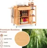 A bamboo kitchen cart with various items on it, accompanied by text highlighting its features and a background image of a bamboo forest. Podgląd zdjęcia produktu