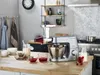 A kitchen counter with a stand mixer and berry press attachment, along with ingredients for making jam or juice. Anteprima dell’immagine prodotto