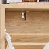 A close-up view of a shelf with a book and a small gray latch attached to the underside of the shelf. Podgląd zdjęcia produktu