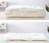 Two images show a vacuum-sealed bag of folded clothes. The top image shows the bag in a more puffed-up state, while the bottom image shows it compressed. Náhľad obrázku produktu