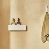 Two bottles of soap dispenser and a towel hanging on a hook on a wall. Produktbild-Vorschau