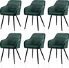 Six green velvet dining chairs are arranged in two rows of three against a white background.